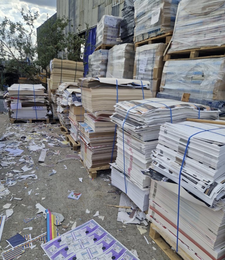 Strapped stacks of printed paper and board on pallets in the Pulp Friction yard