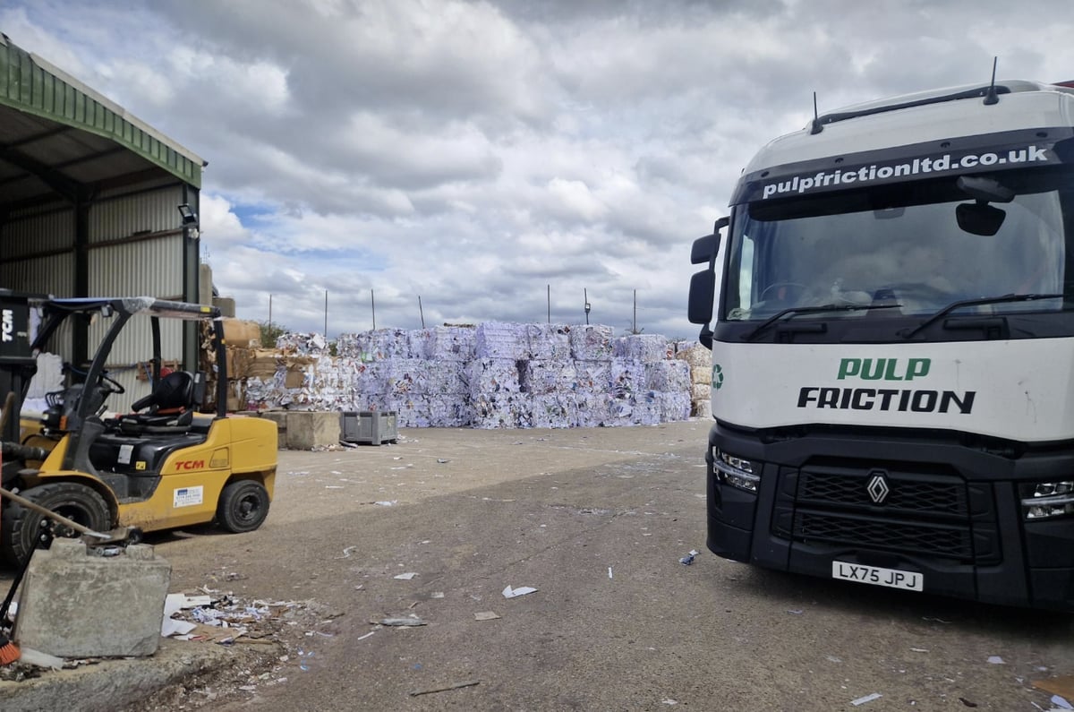 White Pulp Friction lorry parked in the yard beside a forklift and rows of paper bales