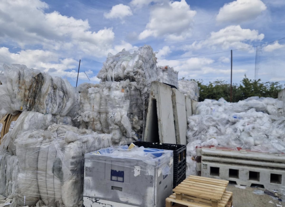 Bales and loose piles of plastic film in the Pulp Friction yard